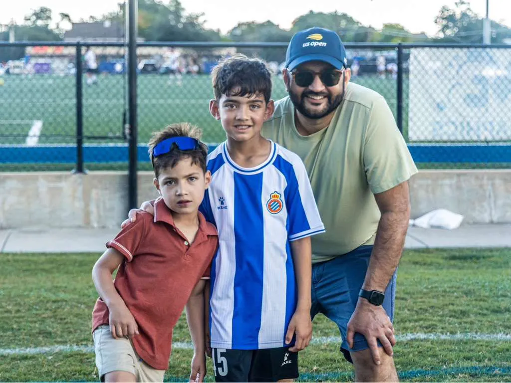 Father with two sons on the sideline