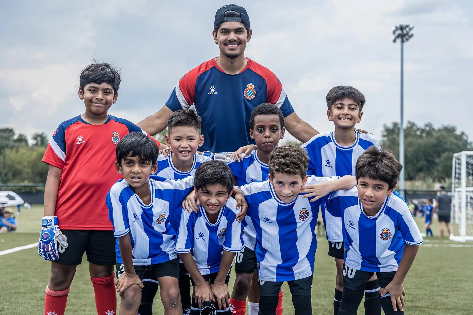 Coach posing with the squad after training in Richmond, TX
