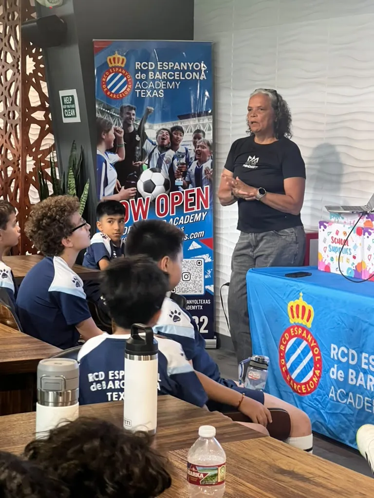 Guest speaker presenting to seated young players