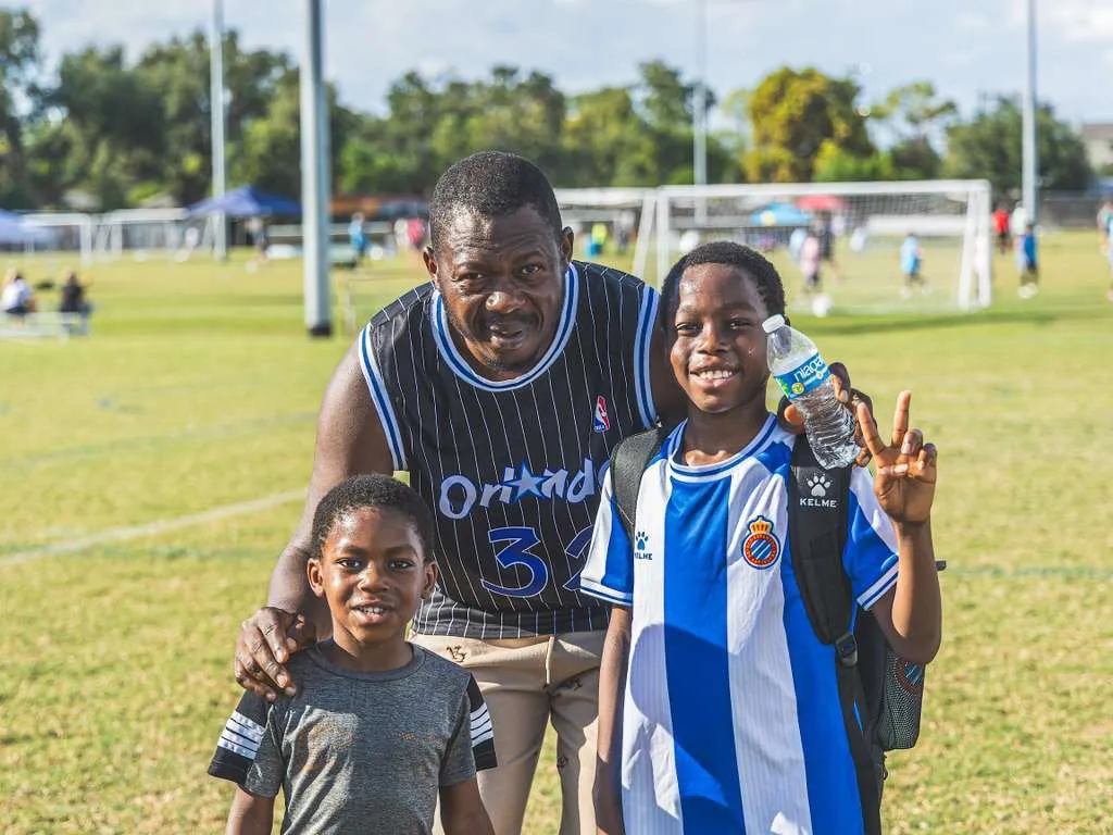 Father with his two boys on the matchday field